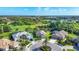 Beautiful aerial view shows the surrounding community, golf course, and tranquil lake at 3337 Pine Shadow Cir, North Port, FL 34287