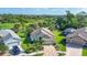 Stunning aerial view of home showcasing landscaping, golf course and serene pond at 3337 Pine Shadow Cir, North Port, FL 34287