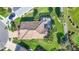 Aerial view of the property showcasing the tile roof, screened lanai, lush landscaping, and community at 3337 Pine Shadow Cir, North Port, FL 34287