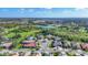 Beautiful aerial view shows the surrounding community, golf course, and tranquil lake at 3337 Pine Shadow Cir, North Port, FL 34287