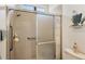 Tiled shower stall with glass doors, grab bar, and updated fixtures at 3337 Pine Shadow Cir, North Port, FL 34287