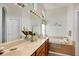 Bathroom features a soaking tub, double sinks, and beach-themed decorations at 3337 Pine Shadow Cir, North Port, FL 34287