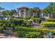 Close exterior view of the clubhouse featuring manicured landscaping and golf cart parking at 3337 Pine Shadow Cir, North Port, FL 34287