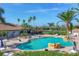 Community pool featuring lounge chairs, tables, and umbrellas, creating a relaxing atmosphere at 3337 Pine Shadow Cir, North Port, FL 34287