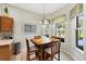 Charming dining area with a wooden table, view to outdoor patio, and tiled floors, perfect for enjoying meals with a view at 3337 Pine Shadow Cir, North Port, FL 34287