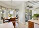 Bright dining nook with a wooden table, view of screened outdoor area, and tiled floor, creating a cozy dining experience at 3337 Pine Shadow Cir, North Port, FL 34287