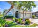 Charming single-story home with lush landscaping, healthy palm trees, and a well-manicured lawn at 3337 Pine Shadow Cir, North Port, FL 34287