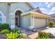 Exterior of home shows lush landscaping, decorative pavers, and a two car garage at 3337 Pine Shadow Cir, North Port, FL 34287