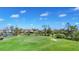 Scenic view of a golf course green with a sand trap, surrounded by lush landscaping at 3337 Pine Shadow Cir, North Port, FL 34287