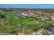 Scenic aerial view of a lush golf course with manicured greens and a serene water feature in gated community at 3337 Pine Shadow Cir, North Port, FL 34287