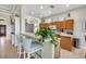Open kitchen with breakfast bar, wooden cabinetry, and modern appliances, providing a functional and stylish cooking space at 3337 Pine Shadow Cir, North Port, FL 34287