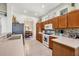 Well-lit kitchen featuring wooden cabinets, modern appliances, and tiled floors, offering a practical cooking and dining area at 3337 Pine Shadow Cir, North Port, FL 34287