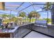 Outdoor kitchen with a high end grill and green space at 3337 Pine Shadow Cir, North Port, FL 34287