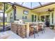 Outdoor kitchen in covered and screened lanai at 3337 Pine Shadow Cir, North Port, FL 34287