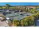 Aerial view of tennis courts, showcasing well-maintained green courts and surrounding landscaping at 3337 Pine Shadow Cir, North Port, FL 34287