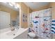 Bathroom featuring a white vanity, toilet, mirror, and shower with a decorative boat themed curtain at 414 Laurel Lake Dr # 203, Venice, FL 34292