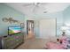 Comfortable bedroom with light blue walls, carpet, ceiling fan, and closet for storage at 414 Laurel Lake Dr # 203, Venice, FL 34292