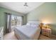 Inviting bedroom with a cozy bed, neutral color scheme, and natural light from the window at 414 Laurel Lake Dr # 203, Venice, FL 34292