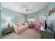 A bright bedroom features a ceiling fan, TV, and window with natural light at 414 Laurel Lake Dr # 203, Venice, FL 34292