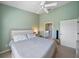 Comfortable bedroom features a neutral color palette, ceiling fan, and access to a bathroom at 414 Laurel Lake Dr # 203, Venice, FL 34292
