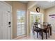 Cozy breakfast nook featuring a bay window, tile floors, and a wooden table set for four at 414 Laurel Lake Dr # 203, Venice, FL 34292