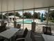 View of the community pool and seating area from the screened-in lanai of this home at 414 Laurel Lake Dr # 203, Venice, FL 34292