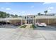 A lovely condo unit features assigned covered parking spots and mature landscaping at 414 Laurel Lake Dr # 203, Venice, FL 34292