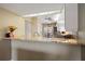 Open kitchen view featuring granite countertops, white cabinetry, and stainless steel appliances at 414 Laurel Lake Dr # 203, Venice, FL 34292