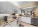 Bright kitchen with granite countertops, white appliances, and ample counter space at 414 Laurel Lake Dr # 203, Venice, FL 34292