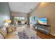 Relaxing living room with balcony access, comfortable seating, and a television at 414 Laurel Lake Dr # 203, Venice, FL 34292