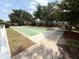 Outdoor shuffleboard court surrounded by greenery and paver walkway at 414 Laurel Lake Dr # 203, Venice, FL 34292