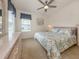 Bright bedroom features a ceiling fan, dresser, and ocean themed comforter set and curtains at 423 Pirates Pt, North Port, FL 34287