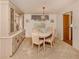 Well-lit dining room with a charming chandelier, seating for six, and ample storage at 423 Pirates Pt, North Port, FL 34287
