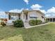 Charming single story home with well-maintained landscaping and a covered entry and porch at 423 Pirates Pt, North Port, FL 34287
