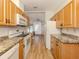 Bright kitchen with wood cabinets, granite counters, and an adjacent breakfast nook at 423 Pirates Pt, North Port, FL 34287
