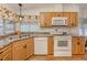 Efficient kitchen design with light wood cabinets, updated appliances, and stylish countertops at 423 Pirates Pt, North Port, FL 34287