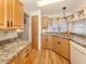 Functional kitchen layout with wood cabinets, modern appliances, and easy-to-clean countertops at 423 Pirates Pt, North Port, FL 34287