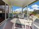 Enclosed lanai features a view of the pond and fountain with a lounge chair at 423 Pirates Pt, North Port, FL 34287