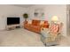 Cozy living room featuring a plush sofa, stylish decor, and neutral carpeting at 423 Pirates Pt, North Port, FL 34287