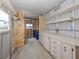 Attached storage room with lots of shelving, cabinets, and room to work and organize at 423 Pirates Pt, North Port, FL 34287