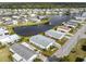 Beautiful aerial view of home surrounded by a lake and lush landscaping at 425 Pirates Pt, North Port, FL 34287