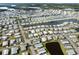 Aerial showing a waterfront community with water views, community pond, and many houses at 425 Pirates Pt, North Port, FL 34287