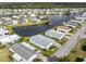 Beautiful aerial view of community, featuring homes surrounding a serene lake with a fountain at 425 Pirates Pt, North Port, FL 34287