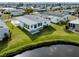 Scenic aerial view of a single-story home with a pond view, situated in a tranquil community at 425 Pirates Pt, North Port, FL 34287