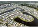 Expansive aerial showing a waterfront community with water views and a community pond at 425 Pirates Pt, North Port, FL 34287