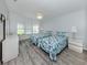 Comfortable bedroom featuring two beds, white cabinetry, and a window for natural light at 425 Pirates Pt, North Port, FL 34287