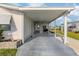 Spacious carport area with room for vehicles and outdoor grilling, with a pond view at 425 Pirates Pt, North Port, FL 34287