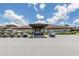 Exterior view of the community clubhouse with golf carts parked outside at 425 Pirates Pt, North Port, FL 34287