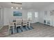Bright dining area featuring a table with seating for six and a modern sideboard at 425 Pirates Pt, North Port, FL 34287