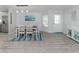 Bright dining room with white wood floors, seating for six, and contemporary decor at 425 Pirates Pt, North Port, FL 34287